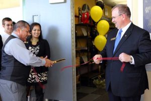 RLHS Principal Ed Delgado (left) cuts the grand reopening ribbon held by SAFE President and Chief Operating Officer David Roughton.